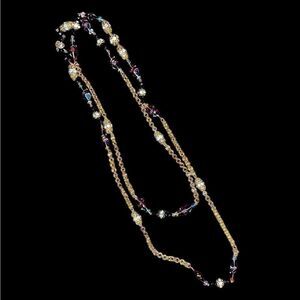 Gold tone long chain for layering has amber gemstones and faux pearls. 59” long